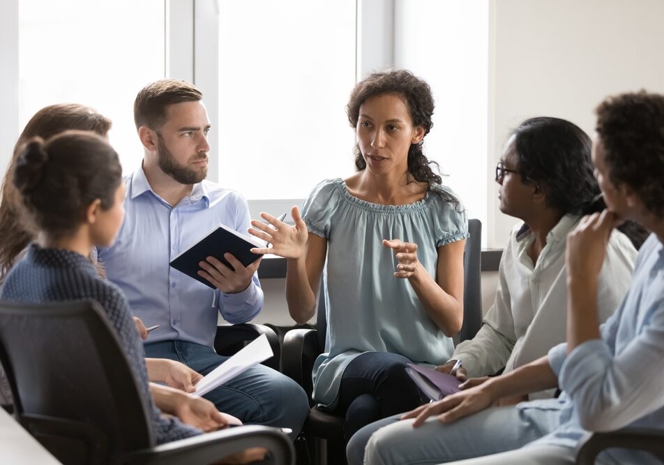 Serious,African,American,Group,Leader,Woman,Speaking,On,Therapy,Meeting.