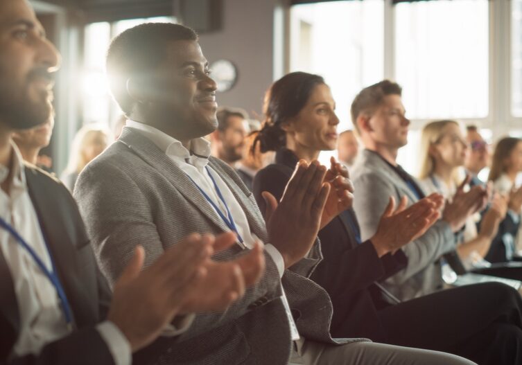 African,American,Man,Sitting,In,Crowded,Auditorium,At,A,Tech